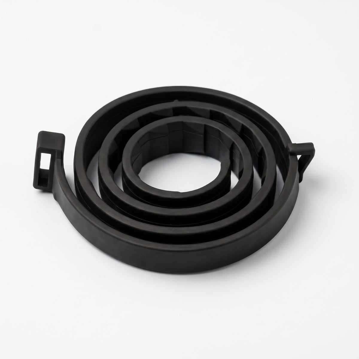 A coiled black rubber or plastic replacement part with small tab-like ends, photographed on a clean white studio background.