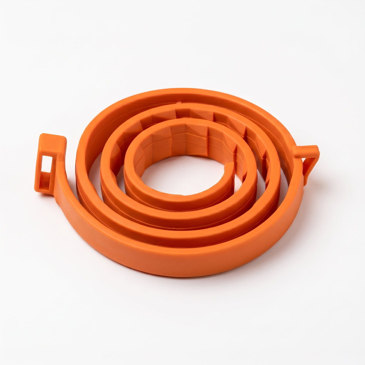 An orange plastic spiral cable guard or loop, shown on a clean white background.